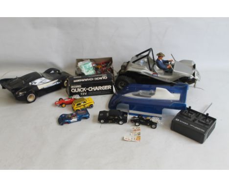 TWO REMOTE CONTROL VEHICLES TO INCLUDE HANDSET, BATTERIES, CHARGER AND ACCESSORIES, together with four various Scalextric car