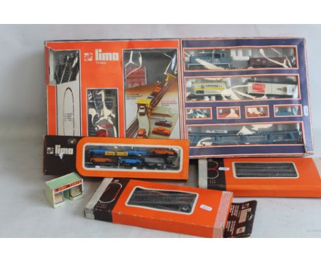 A BOXED LIMA "00" GAUGE TRAIN SET WITH CAR UNLOADING SYSTEM, together with additional boxed track, British Leyland car transp