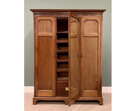 CIRCA 1900 MAHOGANY TRIPLE WARDROBE with inverted stepped cornice and blind fret frieze, the central door with full length be