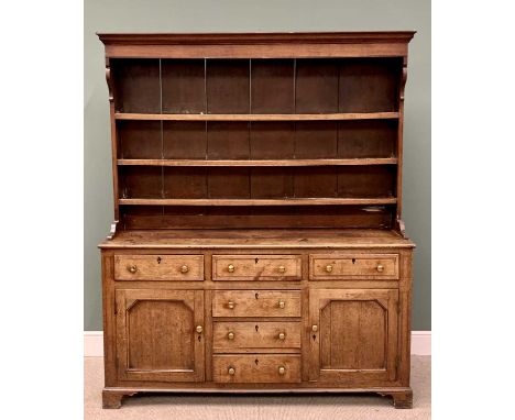 CIRCA 1830 OAK WELSH DRESSER, the three-shelf rack with wide backboards and shaped front detail over a base section having a 