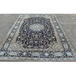 FINE KASHAN RUG, blue ground with stunning central panel of traditional motifs and decorative