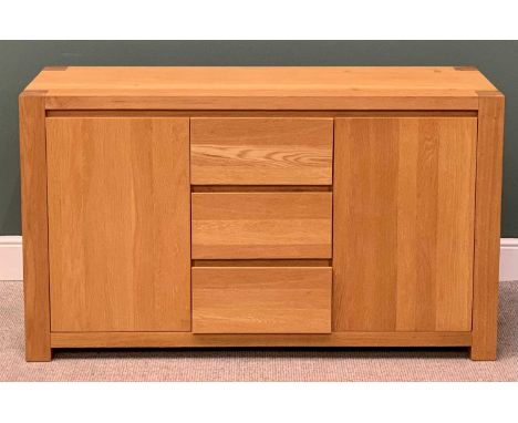 ULTRAMODERN LIGHT OAK SIDEBOARD, having three central opening drawers flanked by twin cupboard doors on substantial block cor