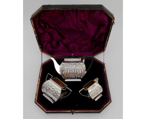 A BACHELOR'S THREE PIECE SILVER TEA SERVICE by Josiah Williams &amp; Company (George Maudsley Jackson), London 1890, of round