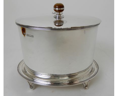 A SILVER BISCUIT BARREL maker's marks C &amp; S Co. Limited, London 1927, of plain oval form, the hinged cover with ball fini