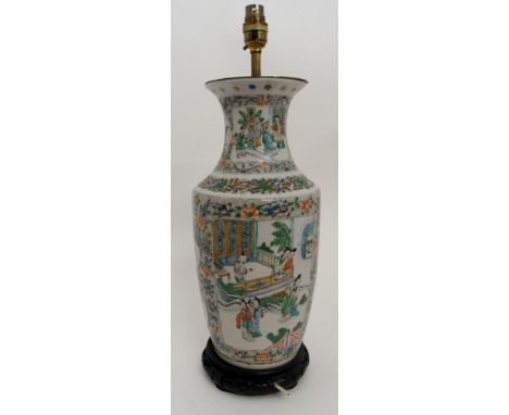 A CHINESE FAMILLE VERTE BALUSTER VASE painted with panels of courtiers in garden palaces within foliate borders on a seed pat