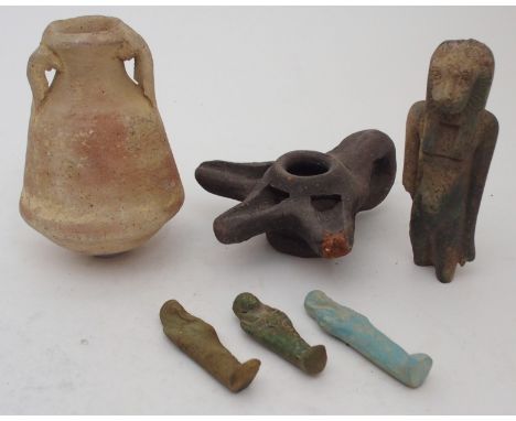 AN EGYPTIAN OIL VESSEL 12cm high, oil lamp, 13cm wide and four shabti, 6, 7, 7.5 and 12cm high (6) Condition Report: larger f