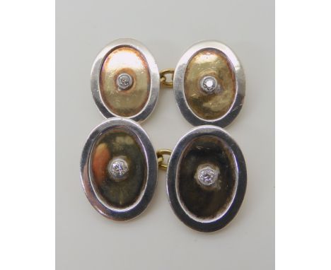 A PAIR OF 18C YELLOW AND WHITE GOLD CUFFLINKS SET WITH DIAMONDS approx dimensions 1.8cm x 1.4cm, with chain linkage. combined