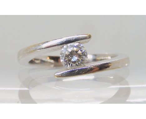 A DIAMOND SOLITAIRE RING set with a brilliant cut diamond of estimated approx 0.30cts, in a simple tension setting in white m