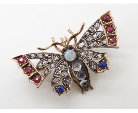 A YELLOW AND WHITE METAL DIAMOND AND GEM SET BUTTERFLY BROOCH with pierced wings, set with rubies, sapphires, rose cut diamon