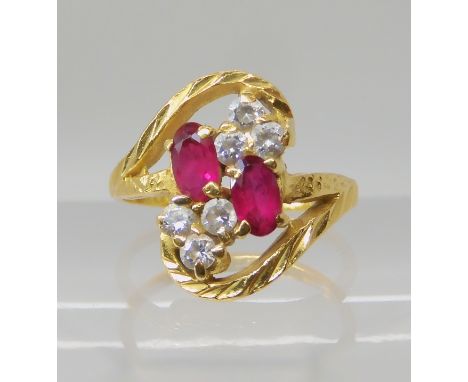 A BRIGHT YELLOW METAL RED AND CLEAR GEM SET RING finger size J1/2, weight 4gms Condition Report: Available upon request