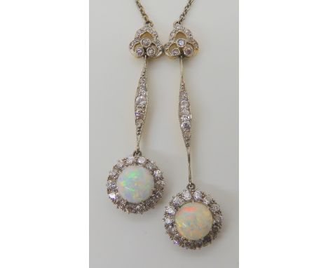 A BELLE EPOCHE STYLE DOUBLE OPAL AND DIAMOND DROP PENDANT set throughout in yellow and white metal, the round opals are appro