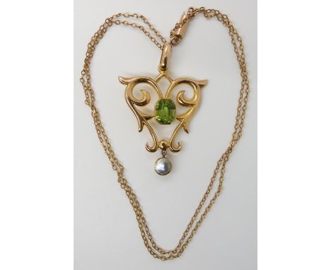 A 15CT GOLD EDWARDIAN PERIDOT AND MOTHER OF PEARL PENDANT dimensions 4.1cm x 2.8cm, length of the 9ct gold chain 44cm, size o