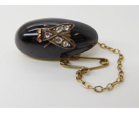 A VICTORIAN GARNET AND DIAMOND SET FLY BROOCH the fly symbolized humility to the Victorians, this example is in white and yel