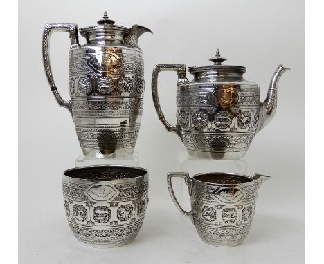 A FOUR PIECE SILVER TEA SERVICE by James Reid & Co, Glasgow 1890 (the water pot 1889), of tapering cylindrical form with foli