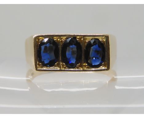 A 14K GOLD GENTS THREE SAPPHIRE RING each sapphire approx 7mm x 4.7mm x 2.3mm, finger size 2 1/2. Weight 8.2gms Condition Rep