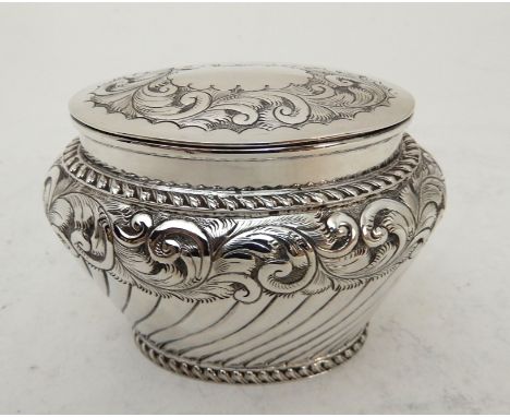 A LATE VICTORIAN SILVER TEA CADDY unclear maker's marks, Birmingham 1897, of tapering oval form, the hinged cover with leafy 