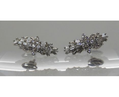 A PAIR OF PLATINUM DIAMOND CLUSTER EARRINGS set with estimated approx 0.50cts of brilliant cut and baguette cut diamonds, wit
