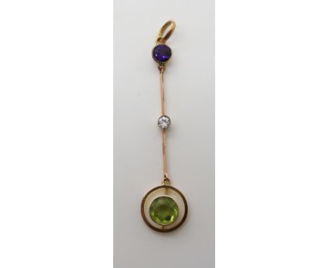 A YELLOW METAL EDWARDIAN DROP PENDANT set with a peridot, diamond (estimated approx 0.10cts) and amethyst, possibly a suffrag