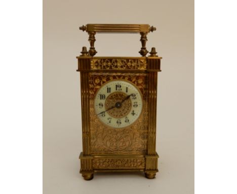 A FRENCH BRASS CASED CARRIAGE CLOCK with gilded fret panels to sides and front, with clear door and panel above escapement, w