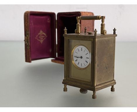 A cased miniature carriage clock, c. 1900, the white enamel dial with Roman numerals within a plain case, in it's original fi