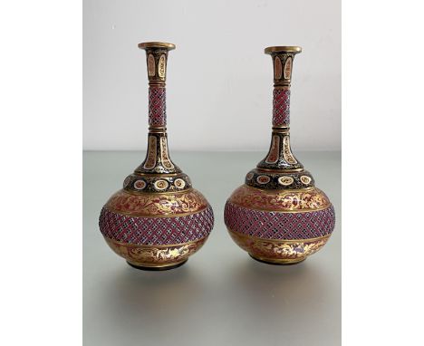 A pair of Bohemian cased cranberry glass vases, 19th century, of flask form, cut and gilt-painted with scrolling foliage and 