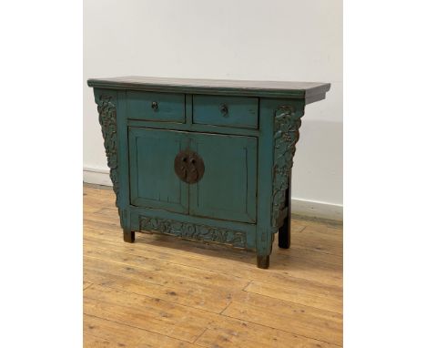 A Chinese side cabinet, late 20th century, the projecting top over two drawers and twin doors opening to a shelf behind, encl