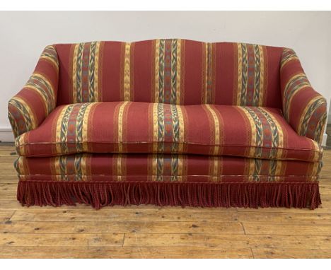 Whytock and Reid, an upholstered three seat sofa, the undulating back and down swept arms enclosing an overstuffed squab cush