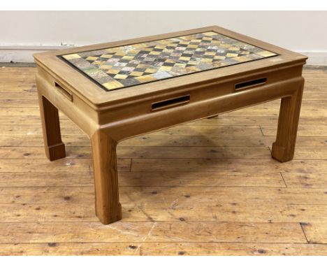 A Chinese style hardwood low table, the top inset with segmented specimen marble panel, above a pierced frieze, raised on mou