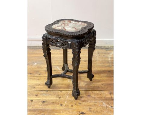 A Chinese hardwood jardiniere stand, late 19th century, the scalloped top centred with inset variegated marble panel framed w