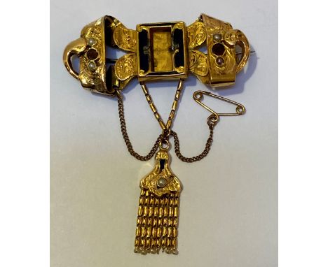 A mid-19th century yellow gold, enamel, garnet and seed pearl mourning brooch, (unmarked but tested as 18ct gold), the centra