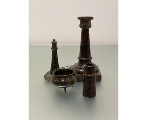 A group of late 19th/early 20th century serpentine desk ornaments comprising: a candlestick, the stone with red inclusions, o