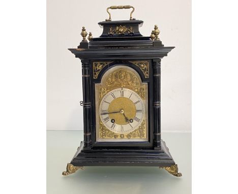 A late 19th century gilt-metal mounted ebonised bracket clock, the silvered chapter ring with Roman numerals, within gilt spa