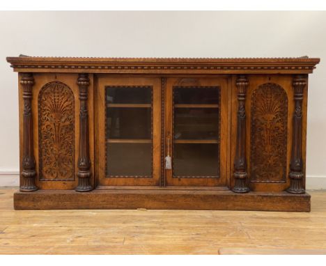 A mid 19th century burr walnut credenza, the top with floral cast gallery over twin glazed doors enclosing two adjustable she