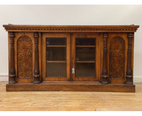 A mid 19th century burr walnut credenza, the top with floral cast gallery over twin glazed doors enclosing two adjustable she