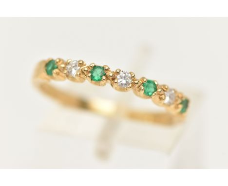 AN 18CT GOLD EMERALD AND DIAMOND HALF ETERNITY RING, set with four small circular cut emeralds interspaced with three round b