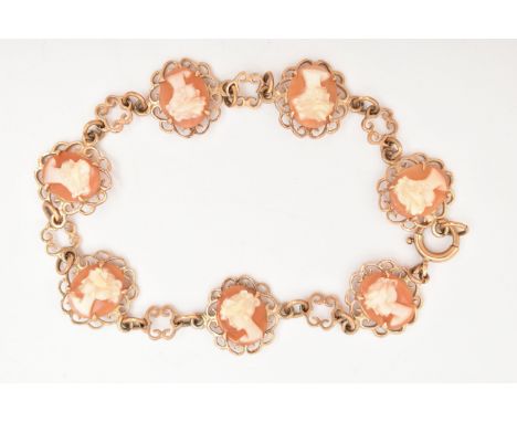 A 9CT GOLD CAMEO BRACELET, designed as a series of seven oval carved shell cameos each depicting a lady in profile, claw set 