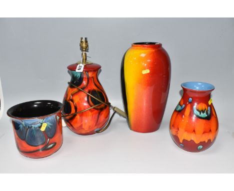 A GROUP OF FOUR POOLE POTTERY DECORATIVE ITEMS comprising a red 20cm volcano vase (crazing apparent to some areas), a red flo