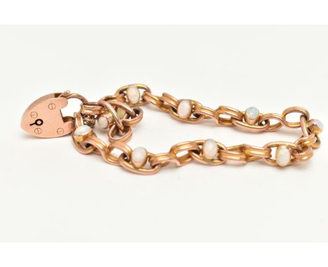 AN EARLY 20TH CENTURY 9CT ROSE GOLD OPAL BRACELET, designed as a series of ten white opal cabochons collet set in oval links,