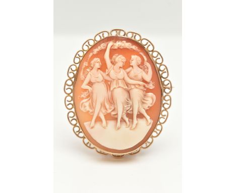 A 9CT GOLD CAMEO BROOCH, of an oval form set with a carved shell cameo depicting the Three Graces, collet set within a scallo
