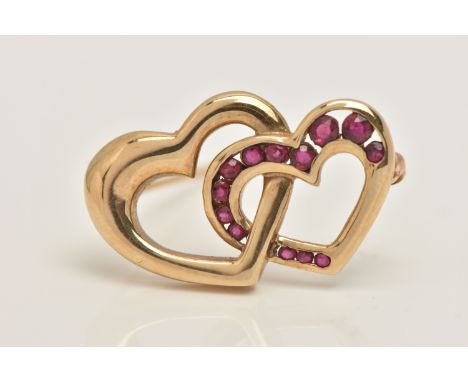 A 9CT GOLD HEART BROOCH, two open work interlocking hearts one set with a row of square cut rubies, fitted with a brooch pin 
