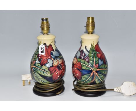 A PAIR OF MOORCROFT BALUSTER LAMP BASES designed by Philip Gibson for Moorcroft Pottery with a tube-lined Simeon pattern of b