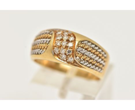A YELLOW METAL DIAMOND RING, pave set with a row of single cut diamonds, flanked with bi-colour wire work to the polished ban