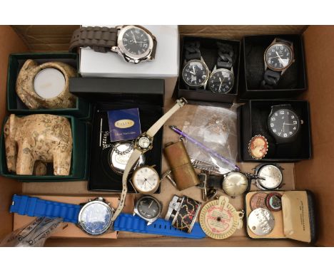 A BOX OF ASSORTED ITEMS, to include a pair of boxed carved stone elephant tea light holders, a selection of fashion wristwatc