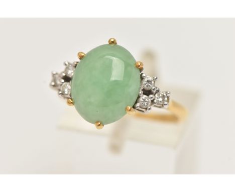AN 18CT GOLD JADE AND DIAMOND RING, set with an oval green jade cabochon in a six claw setting, flanked with six round brilli