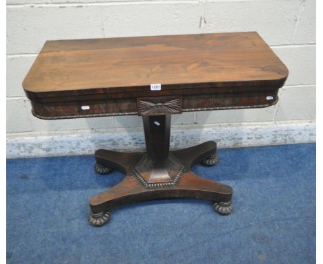 A GEORGE IV ROSEWOOD FOLD OVER CARD TABLE, with green baize playing surface, supported by a flared hexagonal pedestal, and co