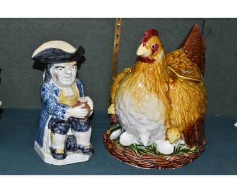 AN EARLY NINETEENTH CENTURY TOBY JUG AND A MODERN NOVELTY SOUP TUREEN, the jug in the form of a seated Toby figure holding a 