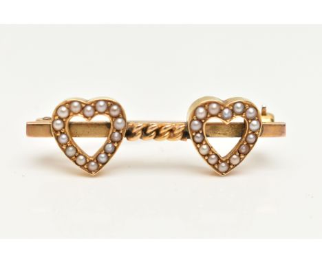 A YELLOW METAL DOUBLE HEART BROOCH, designed with two open work hearts set with split pearls, interspaced with a curb link ch