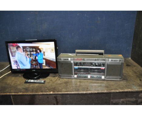 A LOGIK 21.6in TV/DVD WITH REMOTE (PAT pass and working) and a vintage Sanyo portable stereo (PAT fail due to insulated plug 