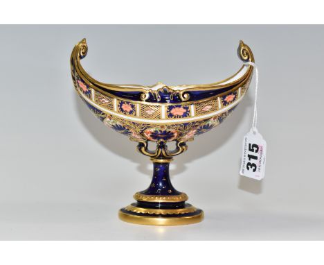 A ROYAL CROWN DERBY IMARI NAVETTE SHAPED PEDESTAL DISH, Imari 1128 pattern, high scroll handles, date cypher 1910, height 14c