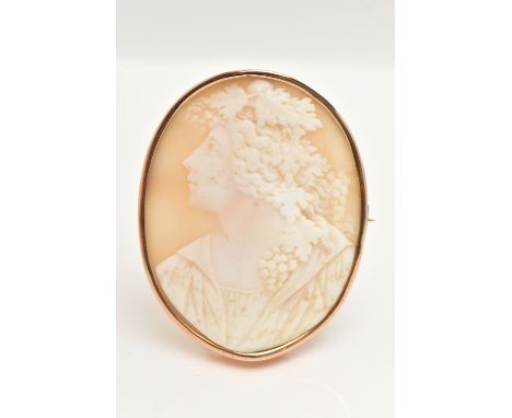 A LARGE YELLOW METAL CAMEO BROOCH, carved shell cameo depicting a gentleman in profile with grapes and vines in hair, collet 